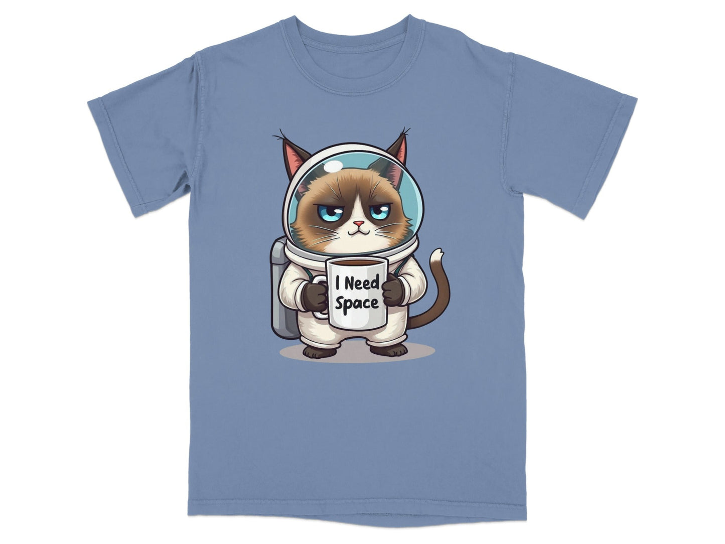 Funny astronaut cat t-shirt with grumpy cat in spacesuit holding "I Need Space" mug, perfect for cat and space lovers.