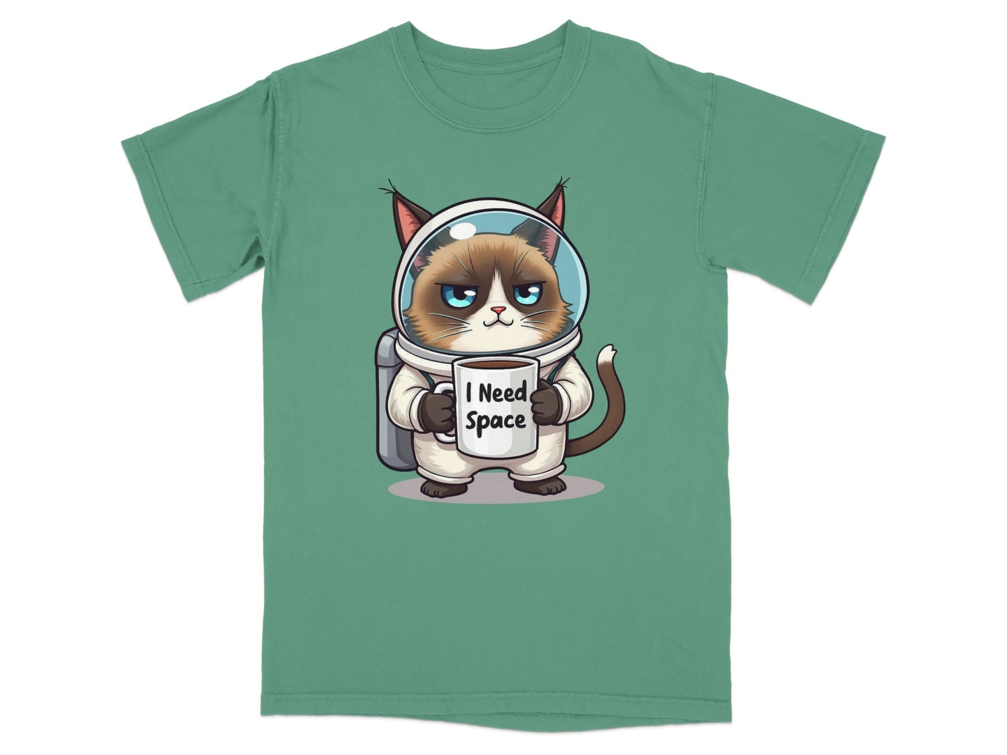 Funny astronaut cat wearing spacesuit holding 'I Need Space' mug on a green t-shirt.
