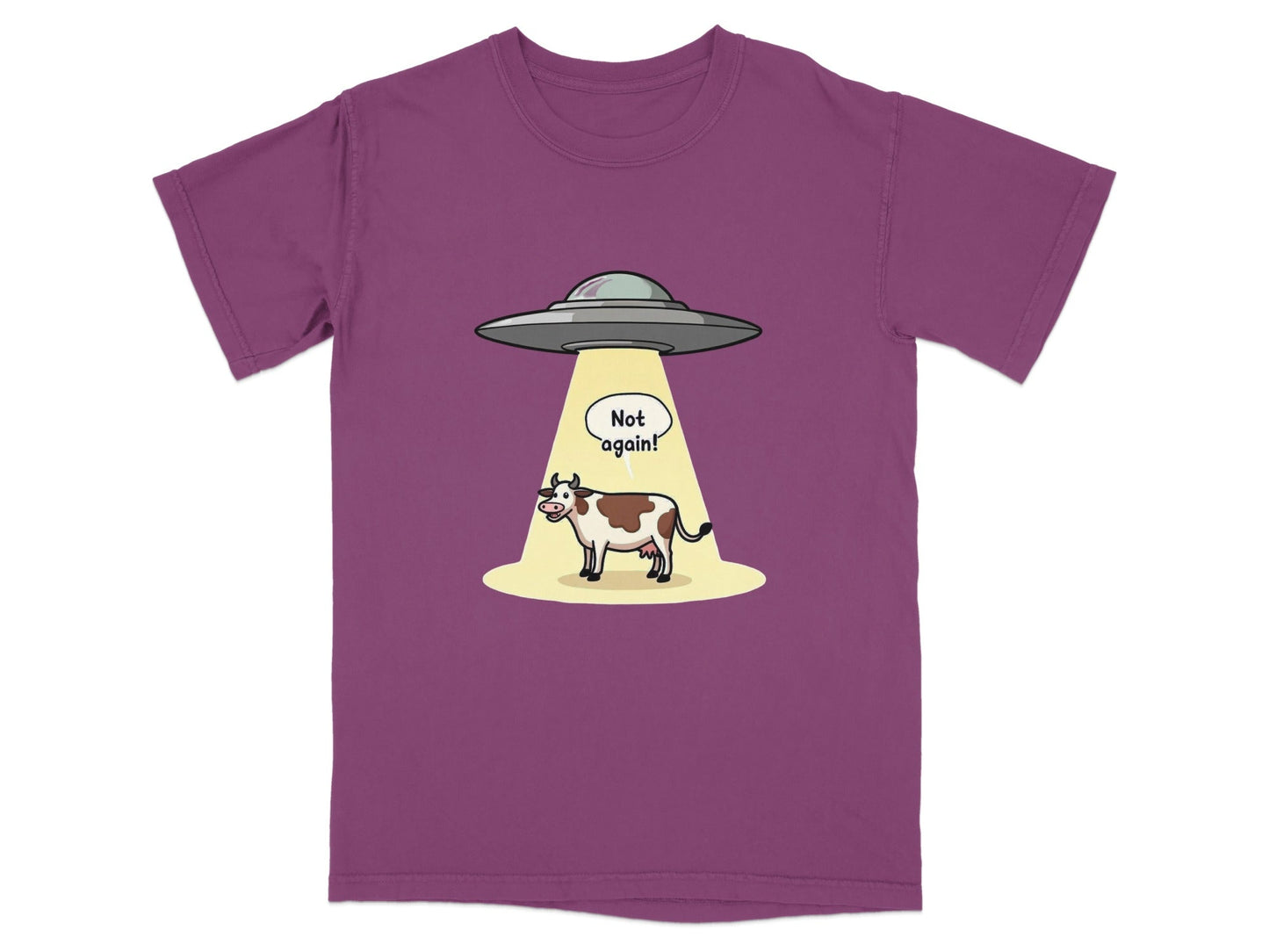 Funny alien abduction cartoon t-shirt featuring a cow and a speech bubble "Not again!" on a purple background.