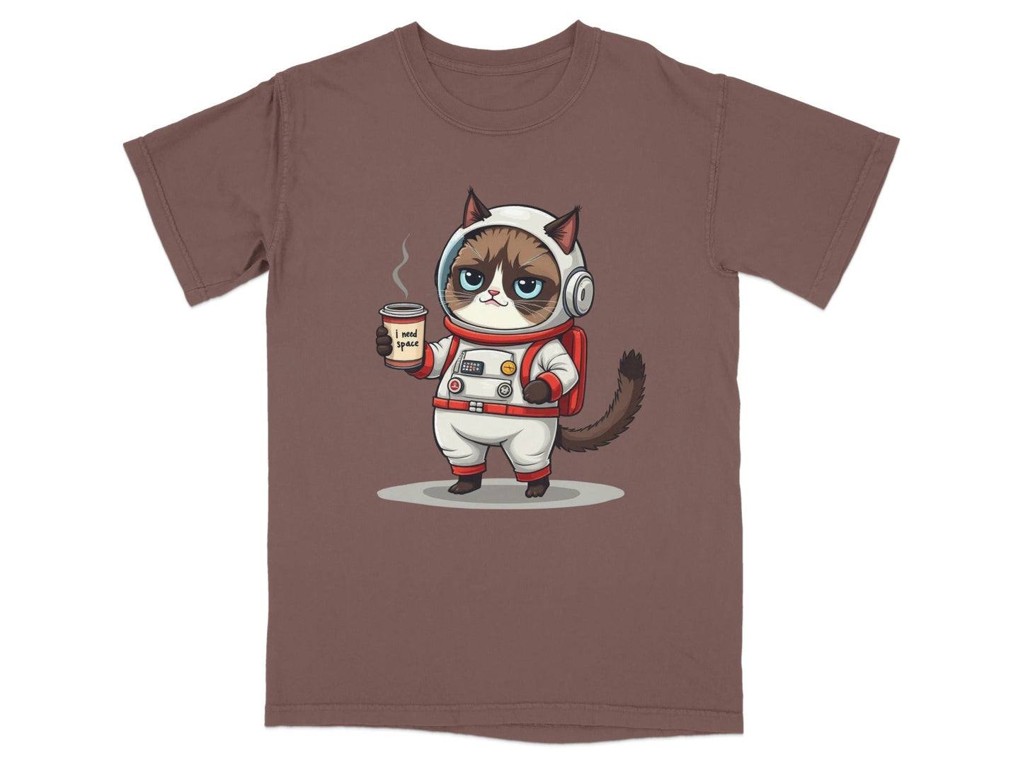 Grumpy astronaut cat t-shirt design with coffee, featuring the quote "I need space" on a brown tee.