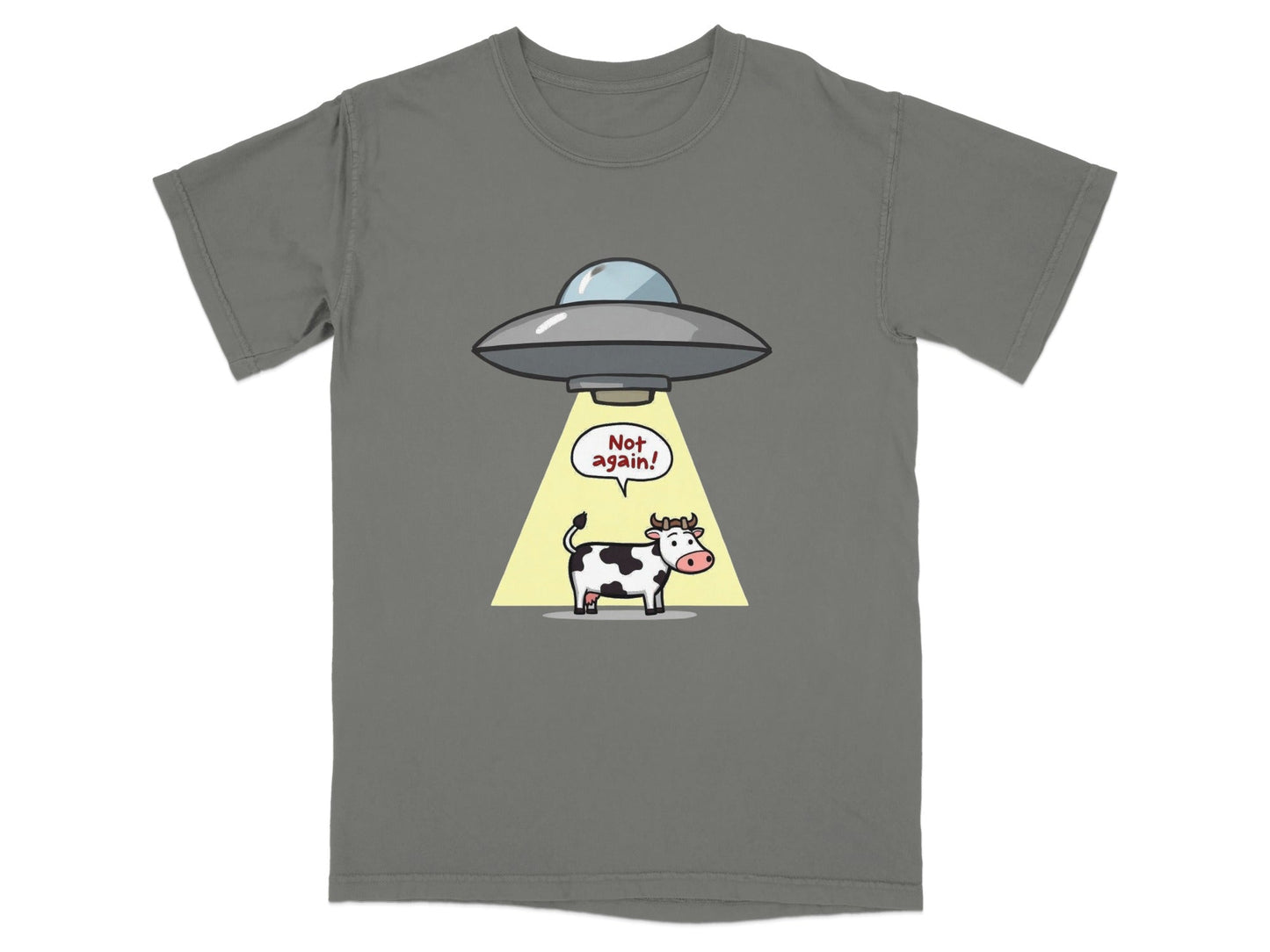 Funny cartoon t-shirt featuring a cow being abducted by a UFO with the text 'Not Again!'. Perfect for alien humor fans.