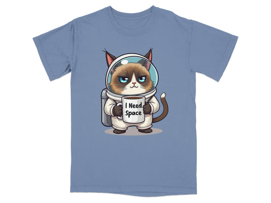 Funny astronaut cat t-shirt with grumpy cat in spacesuit holding "I Need Space" mug, perfect for cat and space lovers.