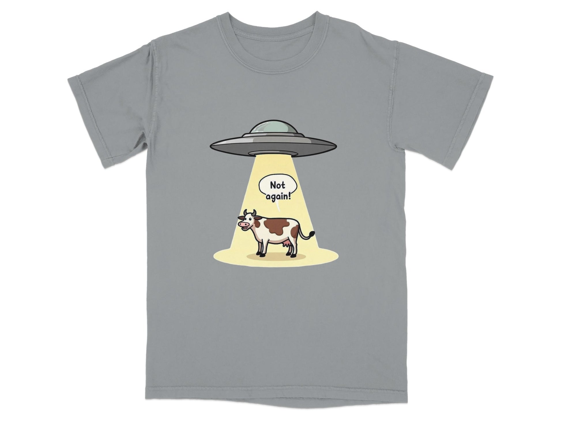 Funny t-shirt with a cow being abducted by aliens and a speech bubble saying 'Not again!'