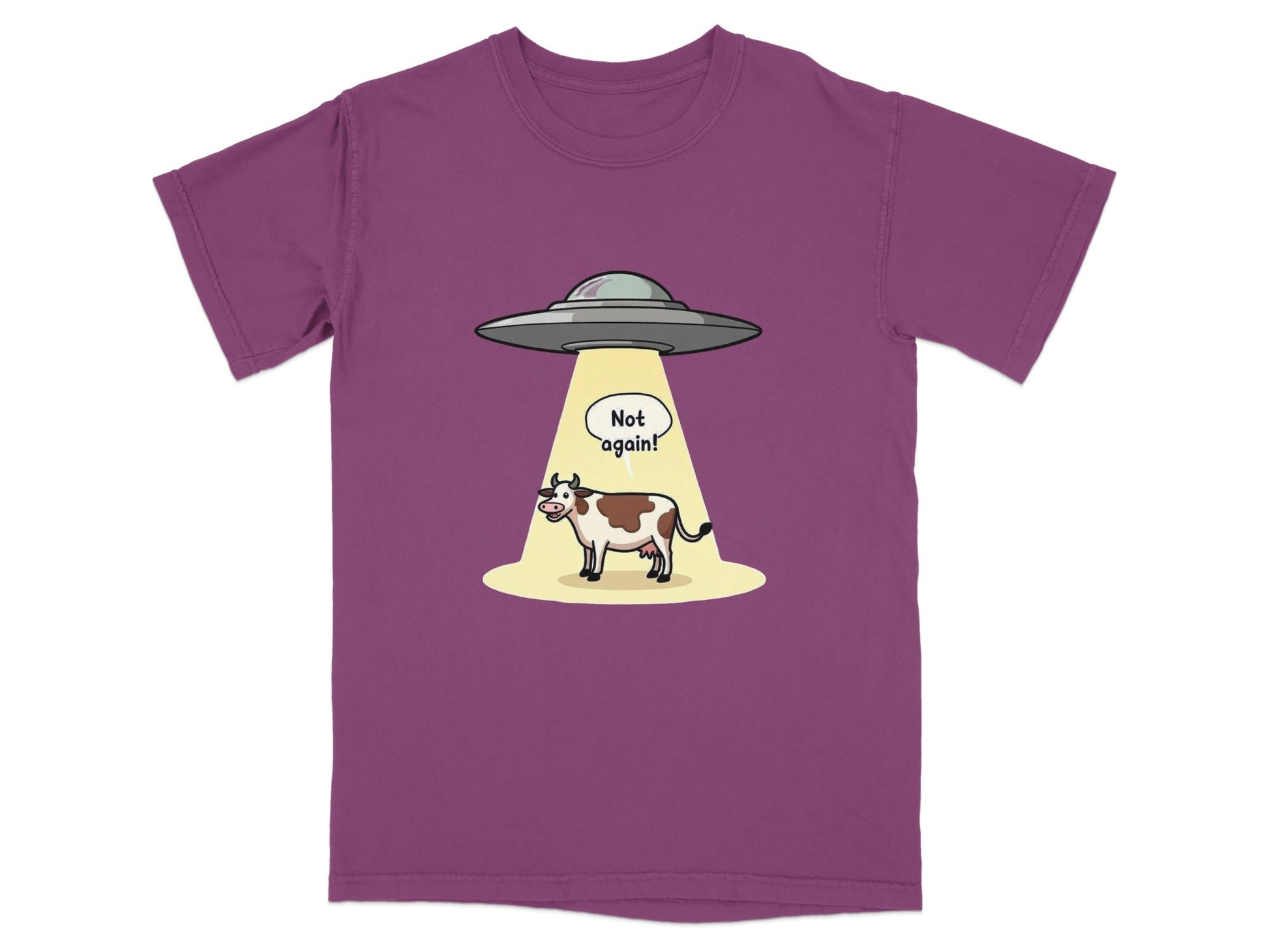 Funny alien abduction cartoon t-shirt featuring a cow and a speech bubble "Not again!" on a purple background.