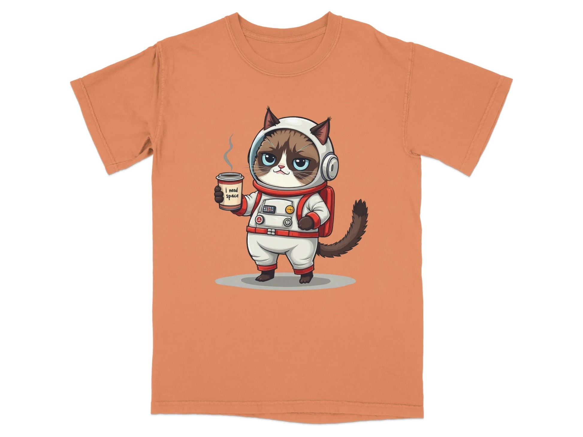 Grumpy astronaut cat t-shirt with the phrase 'I need space' and a coffee cup on an orange background.