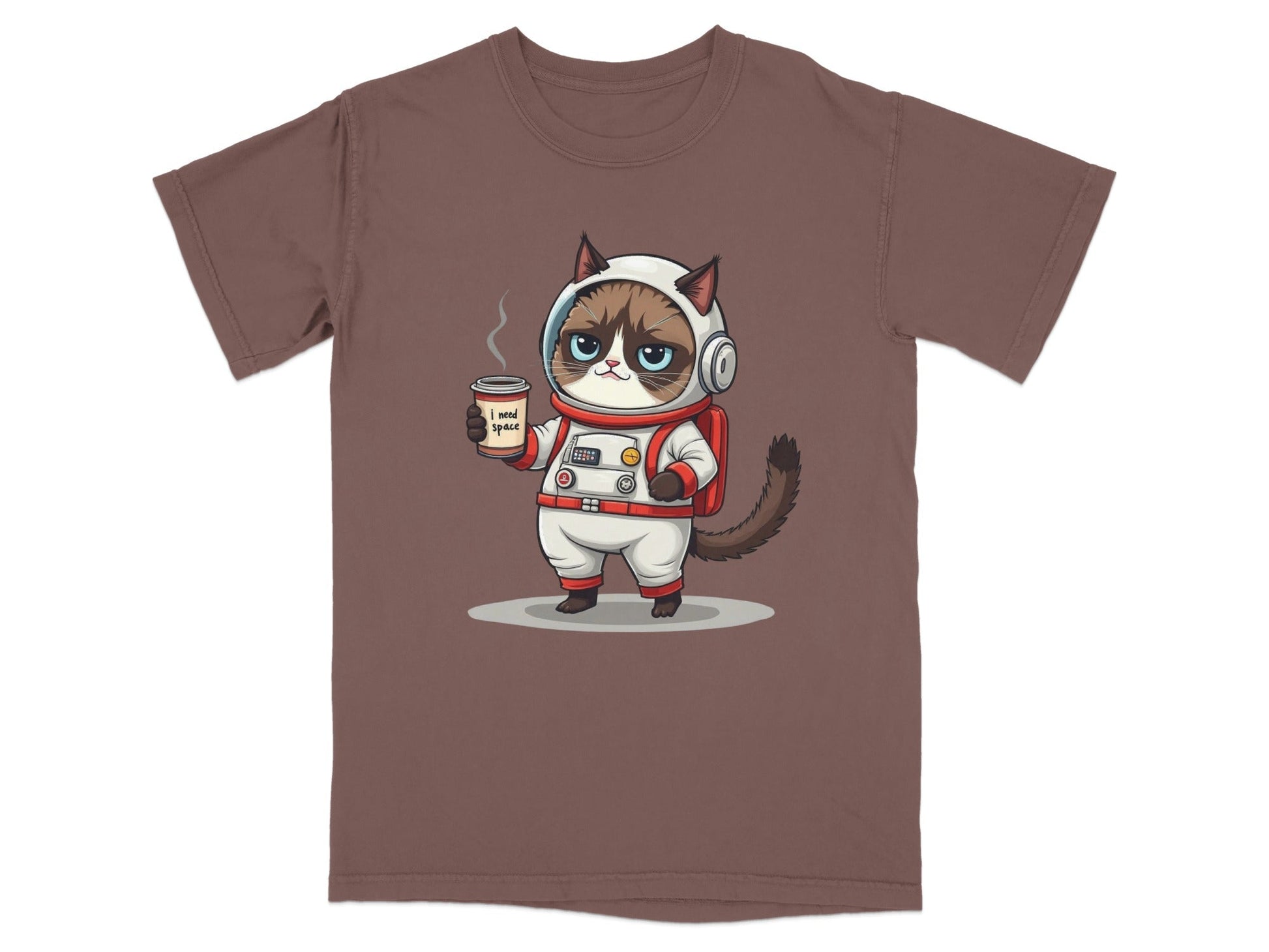 Grumpy astronaut cat t-shirt design with coffee, featuring the quote "I need space" on a brown tee.