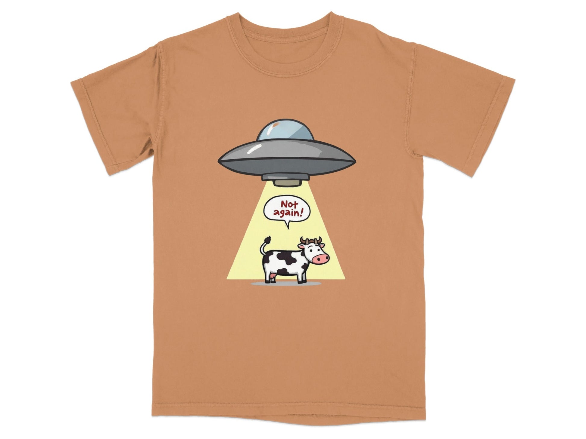 Funny cartoon alien abduction t-shirt featuring a cow and the text 'Not Again!' in a light brown color.