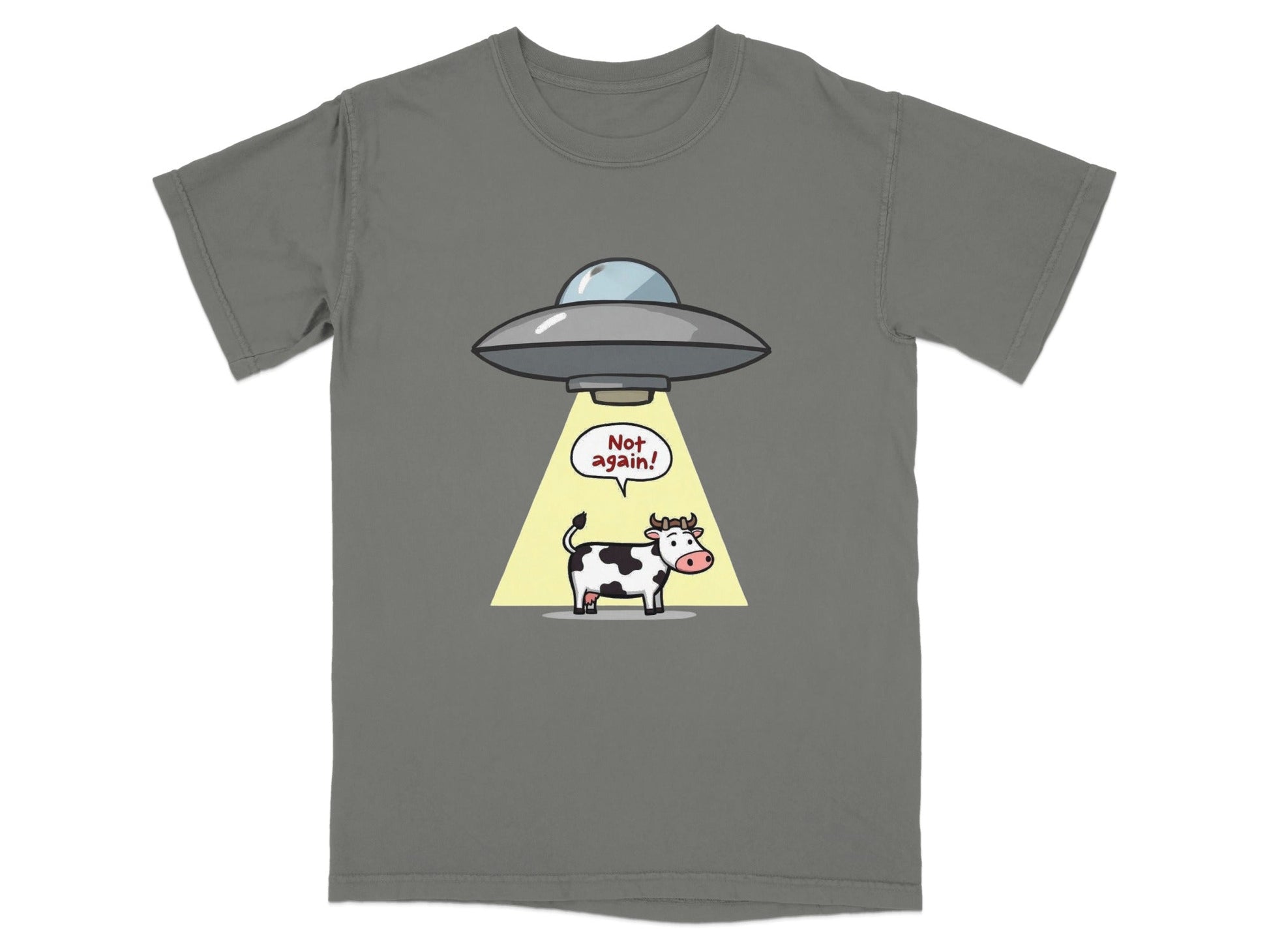 Funny cartoon t-shirt featuring a cow being abducted by a UFO with the text 'Not Again!'. Perfect for alien humor fans.