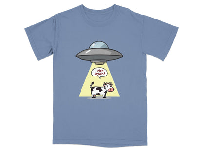 Funny cartoon T-shirt with a cow being abducted by a UFO, featuring the text 'Not again!' for sci-fi fans.