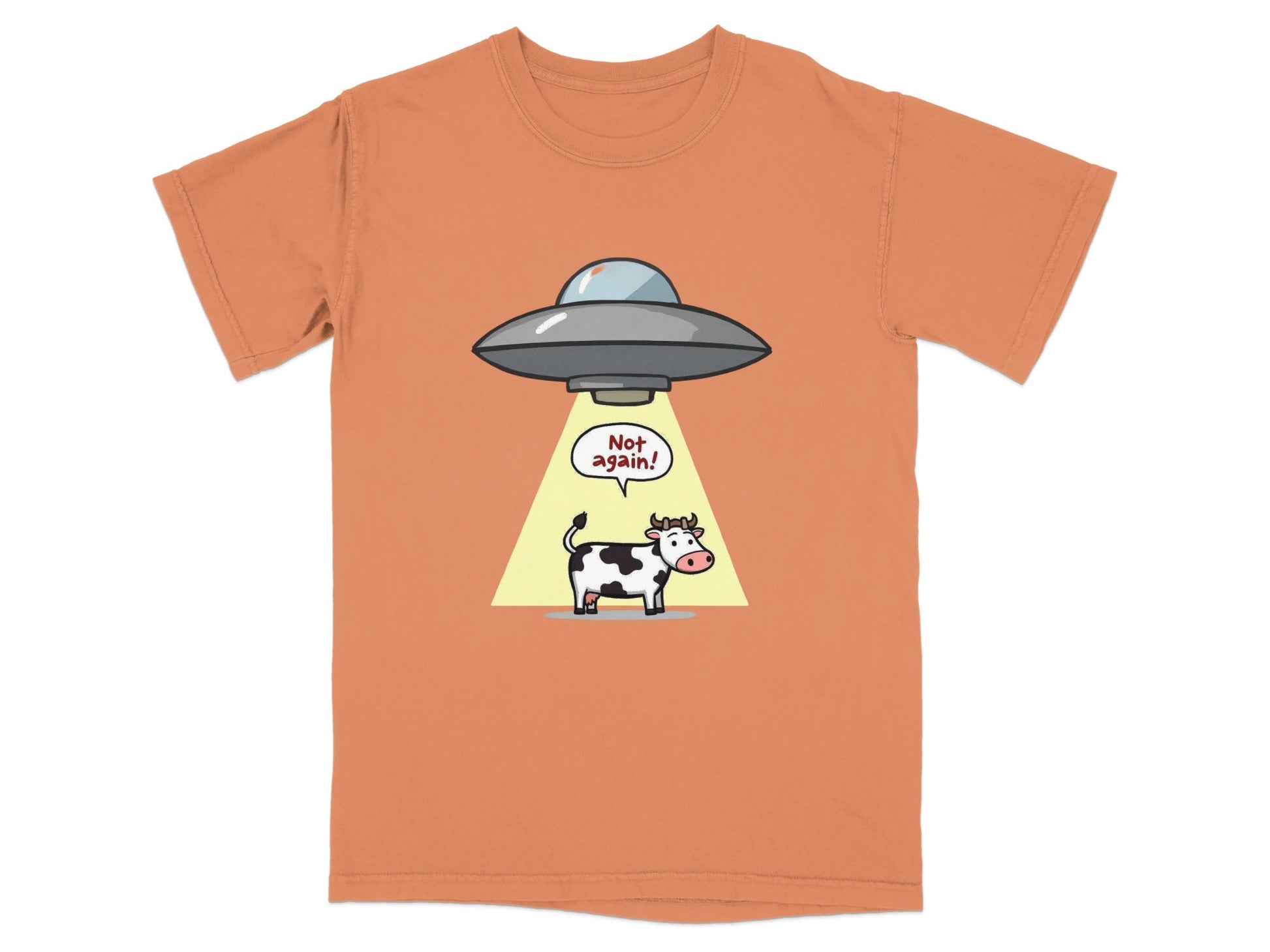 Funny cartoon t-shirt featuring a cow being abducted by a UFO with the text 'Not Again!'. Perfect for sci-fi fans.