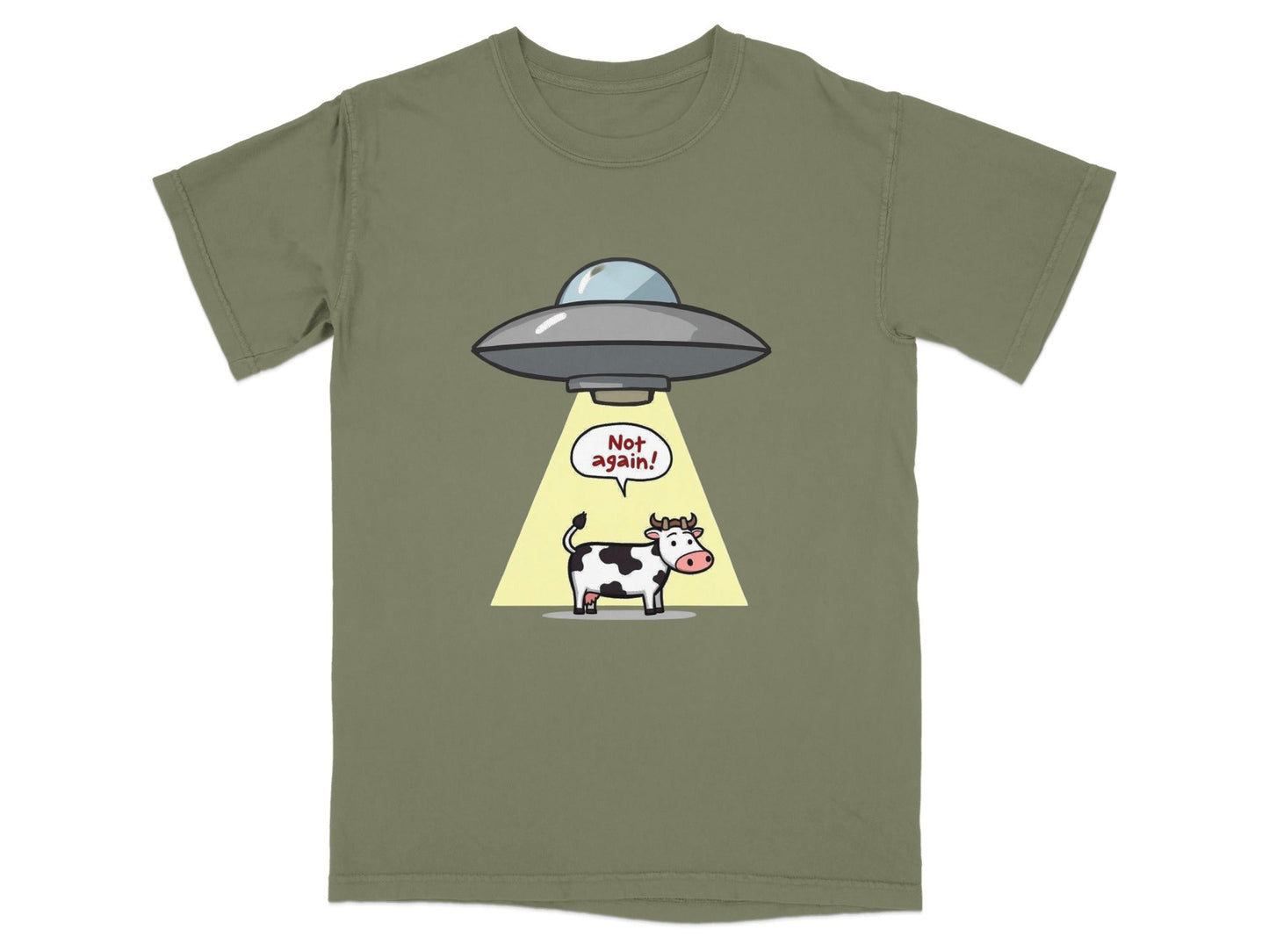 Funny cartoon cow abduction graphic on an olive green t-shirt, captioned 'Not again!' for sci-fi fans.